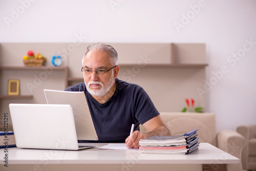 Old male employee working from home during pandemic