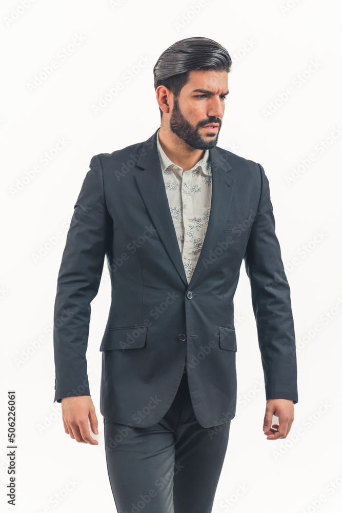 young Latin man wearing a suit fastering a button looking away from camera, isolated white background copyspace. High quality photo young Latin man wearing a suit fastering a button looking away from camera, isolated white background copyspace. High quality photo