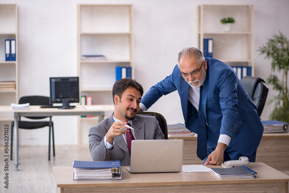Two male colleagues working in the office Two male colleagues working in the office