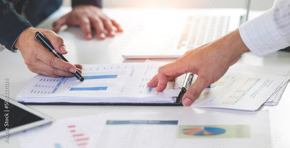 Businessman team working at office with document on his desk, doing planning analyzing the financial report, business plan investment, finance analysis concept. Businessman team working at office with document on his desk, doing planning analyzing the financial report, business plan investment, finance analysis concept.