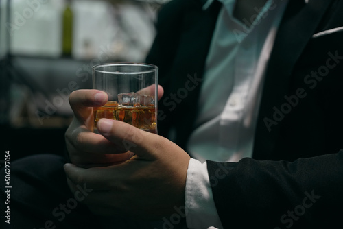 Businessmen in suits drinking Celebrate whiskey