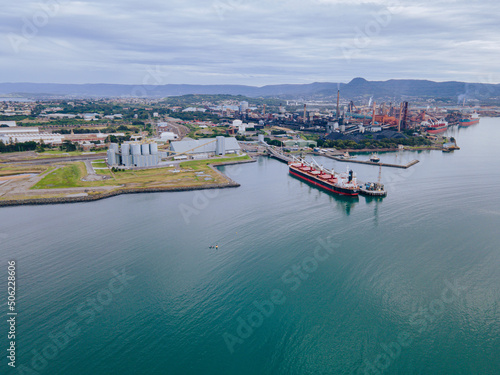 Aerial drone view of Port Kembla, in the Illawarra Region of NSW, showing the seaport, industrial complex and small harbour foreshore 