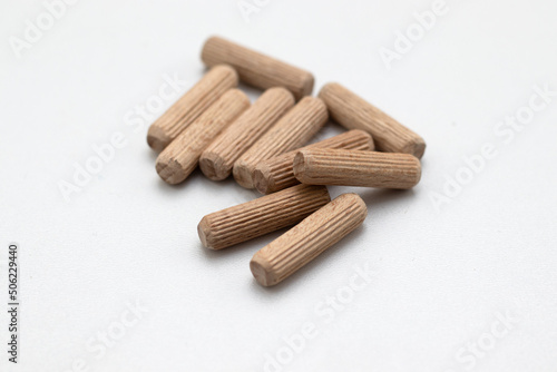Wooden dowels on white background for connection on chipboards