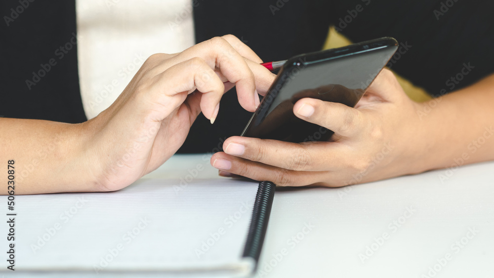 close up hand woman use the smarthphone for work.business technology concept close up hand woman use the smarthphone for work.business technology concept