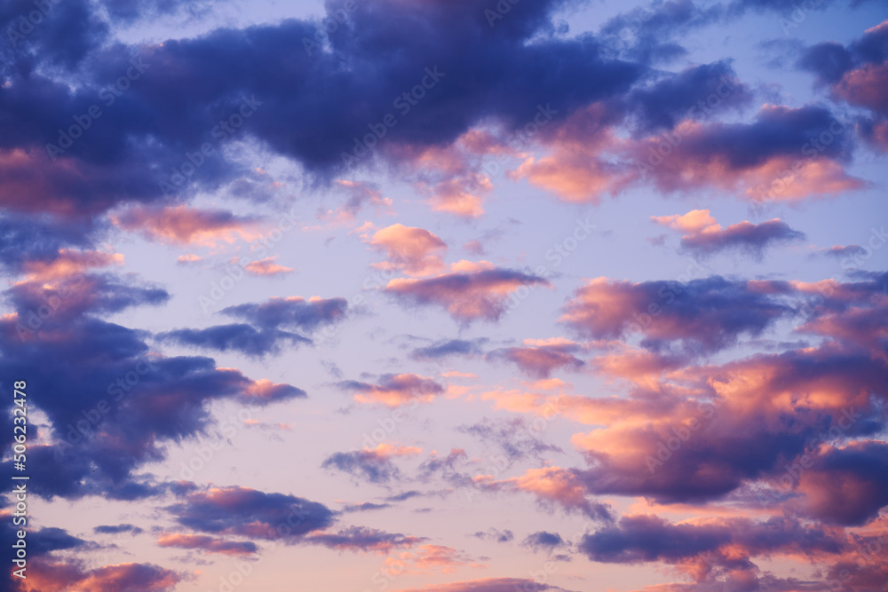 Beautiful sunset sky above clouds with dramatic light. Abstract nature background. Dramatic and moody pink, purple and blue cloudy sunset sky