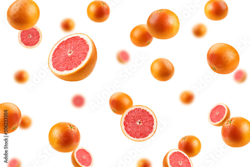 Falling grapefruit isolated on white background, selective focus