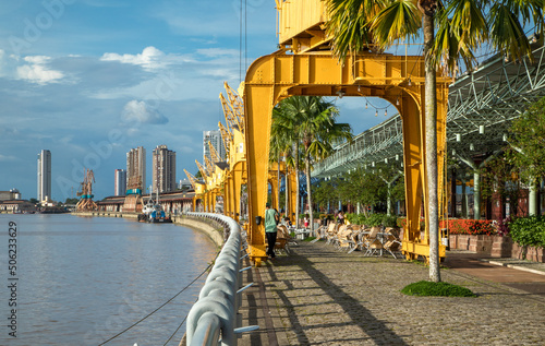 Old port cranes at Estação das Docas, riverside warehouses converted into hub that houses restaurants, bars and shops. Important tourist attraction in Belém do Pará, Amazon, North Brazil.