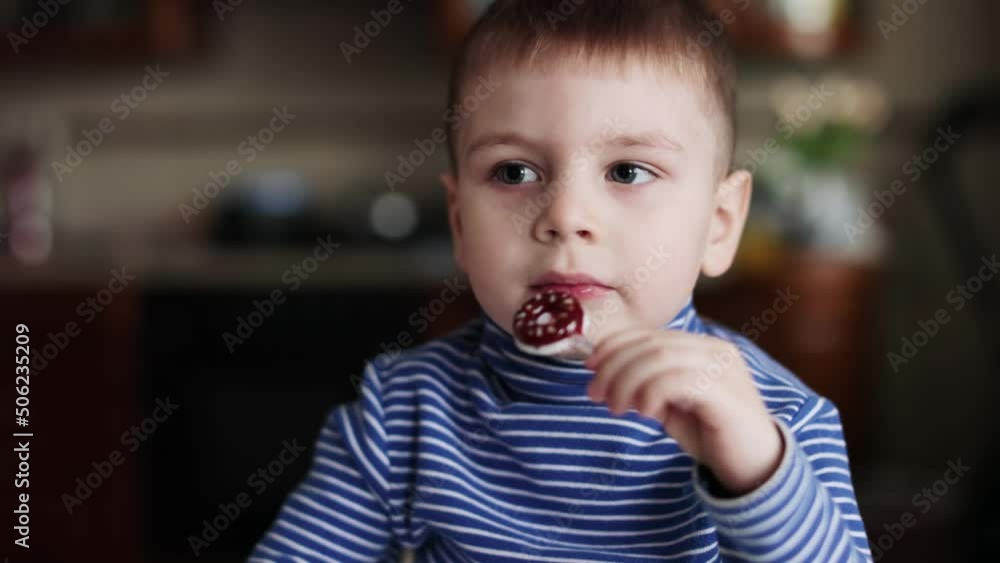 Child boy eating a small donut Child boy eating a small donut