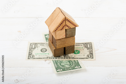 Construction of an original wooden block house for advertising and articles about housing construction and design, developing the imagination Financial protection of life values abstract composition w