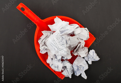 Bucket for collecting garbage with used paper close up on a uniform background cleaning cleanliness