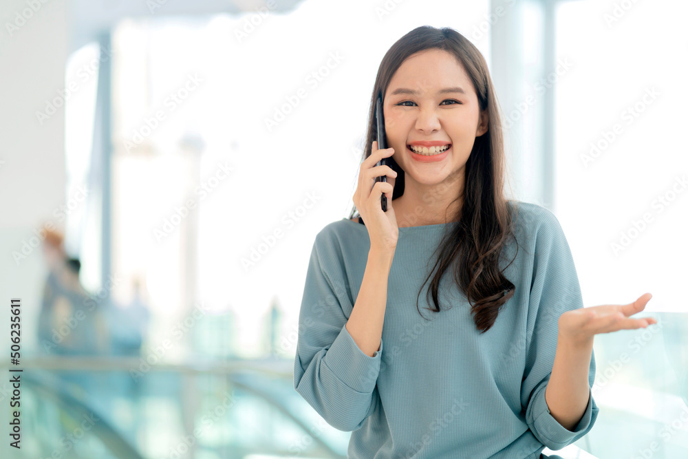 smiling asian female teen hand using smartphone conversation with close friend at mall department store or college corridor cheerful laugh smile positive attitude emotion,young asia woman smartphone smiling asian female teen hand using smartphone conversation with close friend at mall department store or college corridor cheerful laugh smile positive attitude emotion,young asia woman smartphone