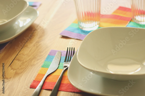 Preparing for dinner during pride month using lgbt flag colored napkins.