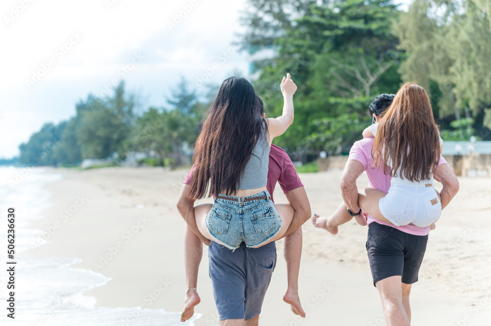 Young woman and man group friends run and enjoy at the beach - summer vacation on sea beach concept Young woman and man group friends run and enjoy at the beach - summer vacation on sea beach concept