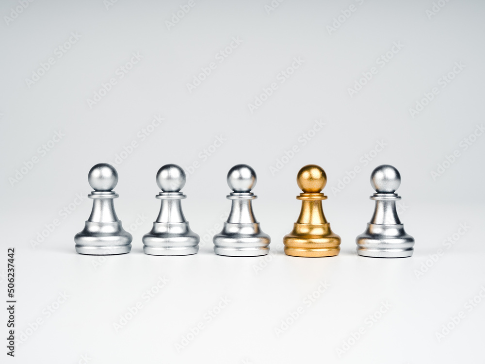 The golden pawn chess piece standing out of the group of silver pawn ...