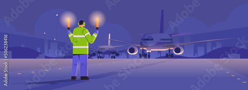 aviation marshaller with light sticks near aircraft air traffic controller airline worker in signal vest professional airport staff
