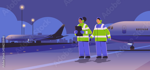 aviation marshallers supervisors near aircraft air traffic controllers airline workers in signal vests professional airport staff