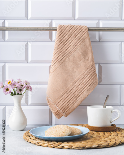 preparing for a tea party on a bright kitchen interior with a beige waffle towel