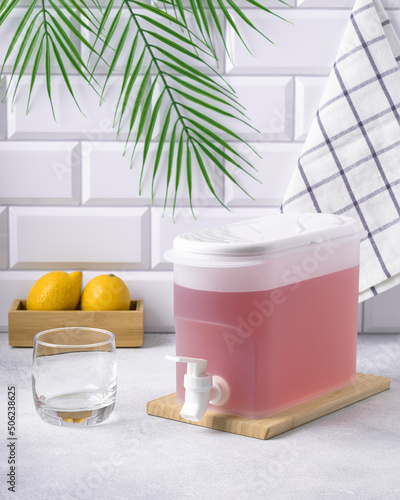 refreshing pink drink in a plastic lemonade bowl in a bright kitchen interior