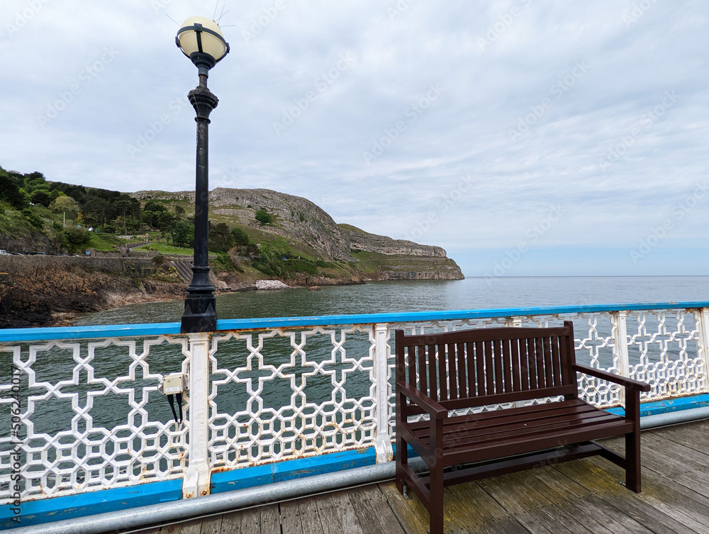 A view from the grade II listed Llandudno pier to Great Orme promontory in North Wales, UK.