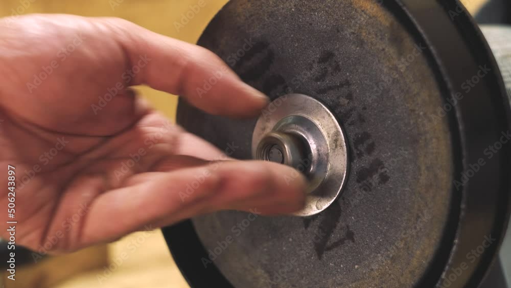 Assembly of the grinder. Grinding machine. Work in the workshop. Production. Metalworking. Man's hands. Close-up. Assembly of the grinder. Grinding machine. Work in the workshop. Production. Metalworking. Man's hands. Close-up.