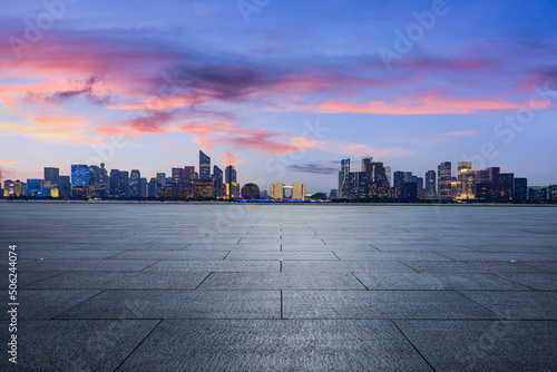 Fototapeta Naklejka Na Ścianę i Meble -  Empty square floor and city skyline with modern commercial buildings in Hangzhou at sunset, China.