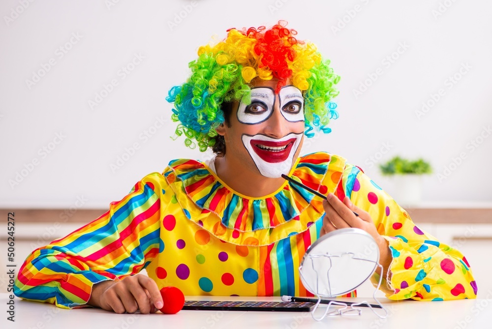 Male clown preparing for perfomance at home Male clown preparing for perfomance at home