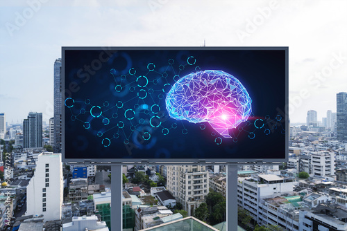 Brain hologram on billboard with Bangkok cityscape background at day time. Street advertising poster. Front view. The largest science hub in Southeast Asia. Coding and high-tech science.
