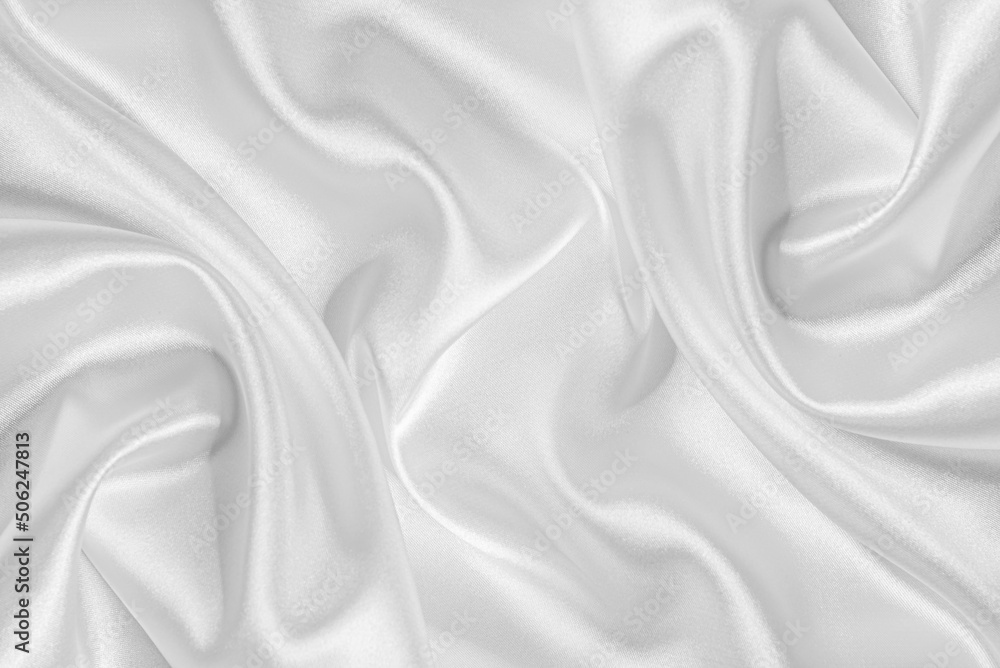 Closeup of rippled white silk fabric. White silk fabric as an abstract background.