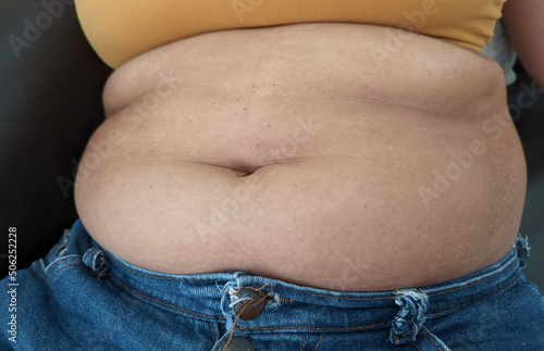 Obraz na plátně Asian Women sitting on show body fat belly front.