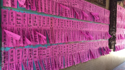  wind blows purple papers with the names of benefactors who donated certain amounts for the benefit of the Thien Hau Temple at Cho Lon. Ancient asian culture photo