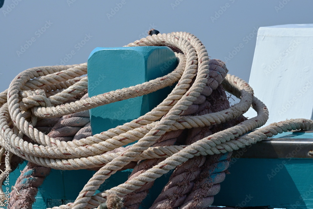 The polypropylene rope is wrapped tightly to the blue front pole near ...