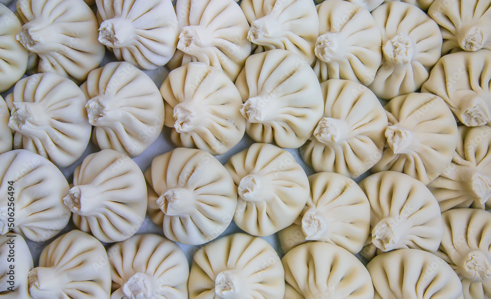 Raw khinkali on the kitchen table. Selective focus. Raw khinkali on the kitchen table. Selective focus.