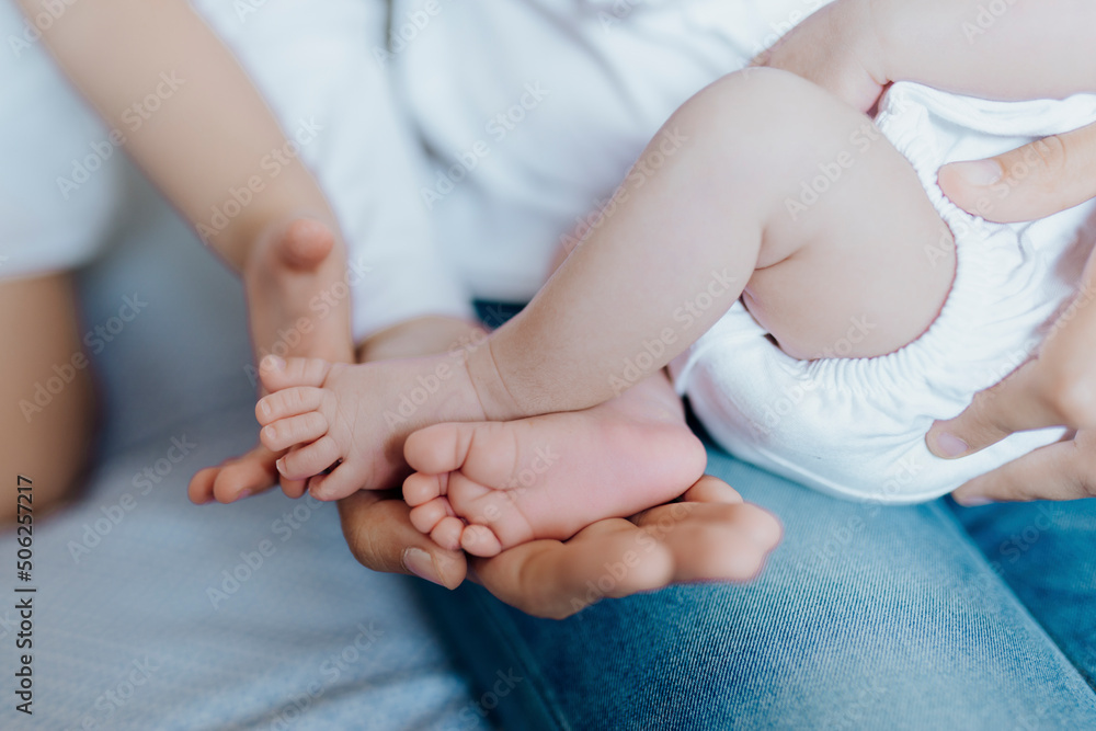 Newborn baby feet on father and sister hands Newborn baby feet on father and sister hands
