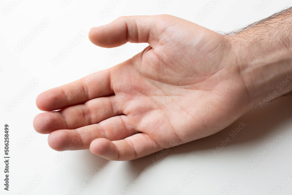 A man's hand is depicted in a close-up palm on a gray background.