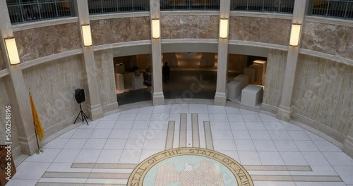 New Mexico State Capital rotunda inside tilt up 4K. Chambers and offices of the New Mexico State Legislature and Governor. Only round capitol building in USA. Polished marble columns, wall, floor. photo