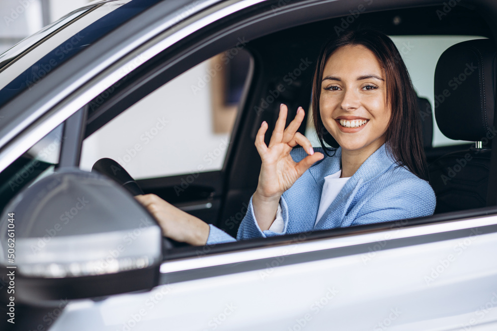 Woman sitting in a car and showing okay sign Woman sitting in a car and showing okay sign