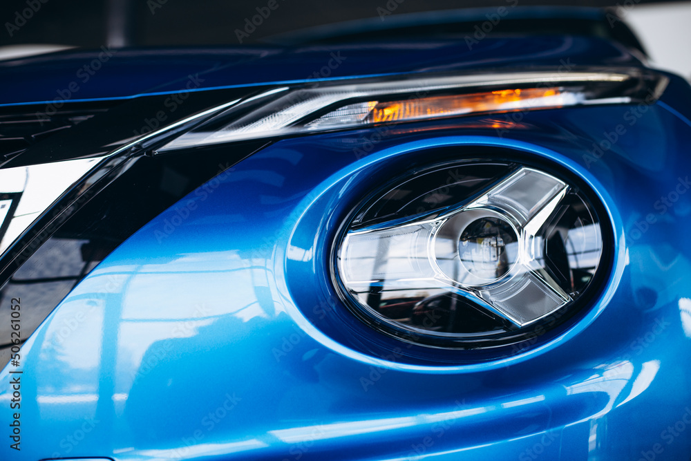 Headlights, car details of a car standing in car showroom Headlights, car details of a car standing in car showroom