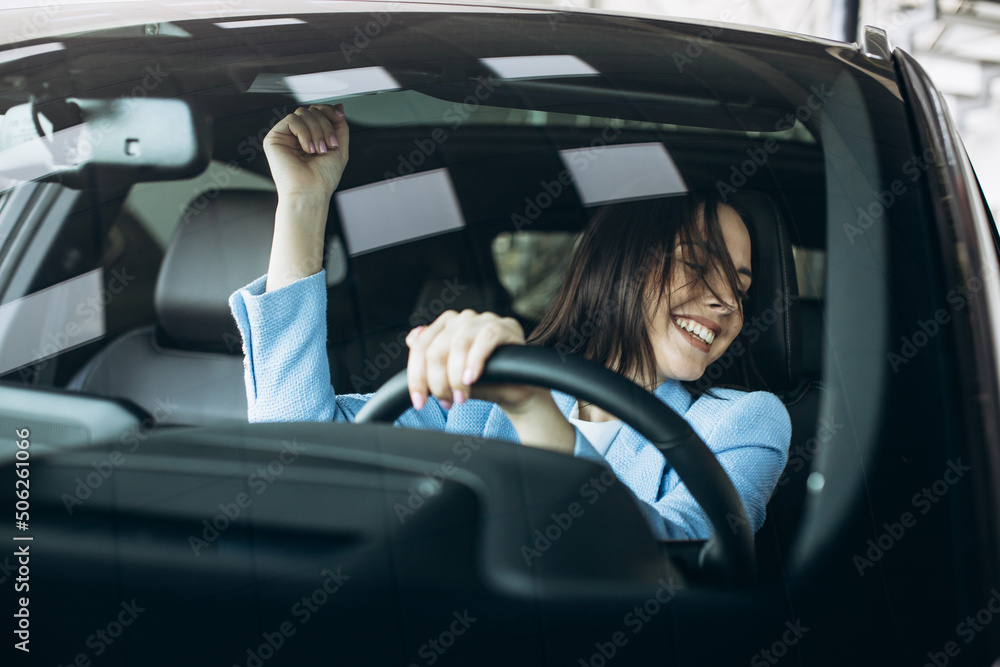 Woman driving car and dancing Woman driving car and dancing