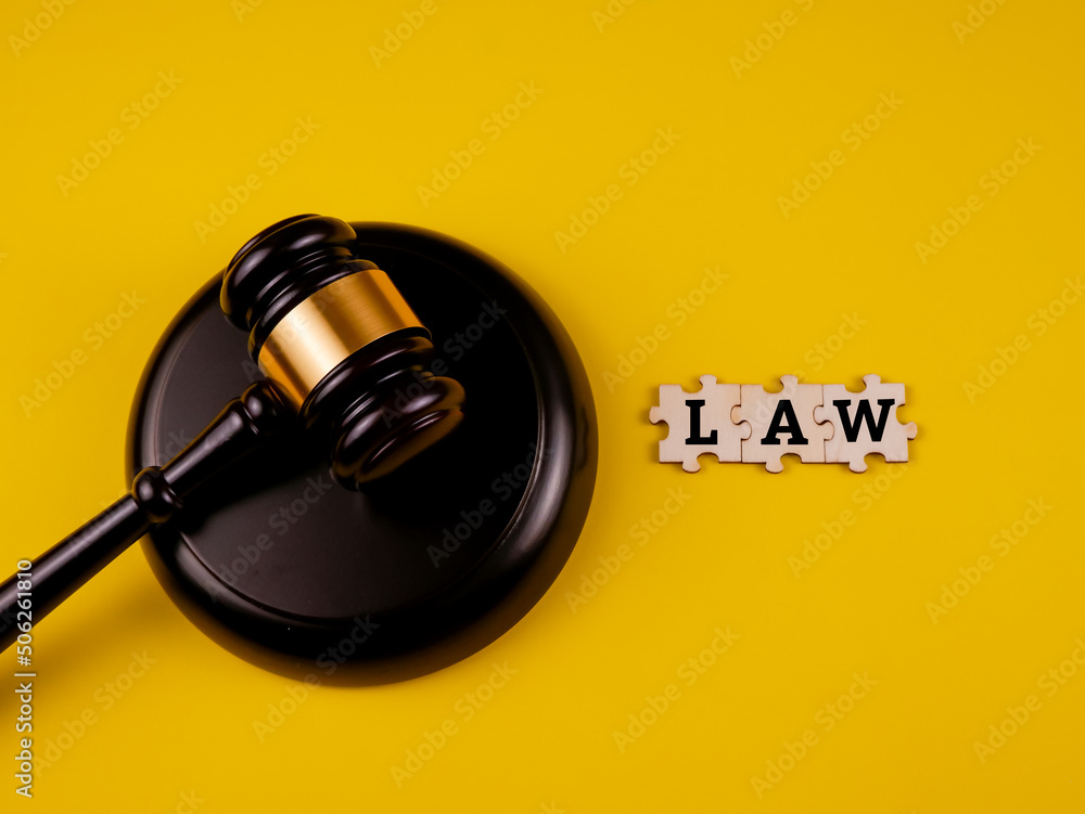 Wooden law gavel and jigsaw puzzle with text 