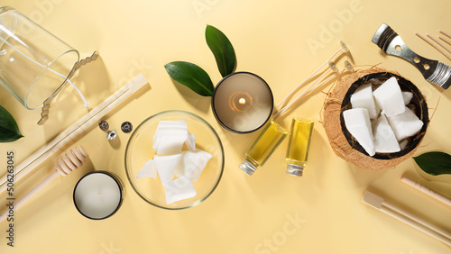Set for homemade natural eco-friendly coconut wax candles, wick, perfume, aroma oil. Candle making utensils.Trendy diy candles to health on beige background.Copy space.Cruelty-free vegan product.