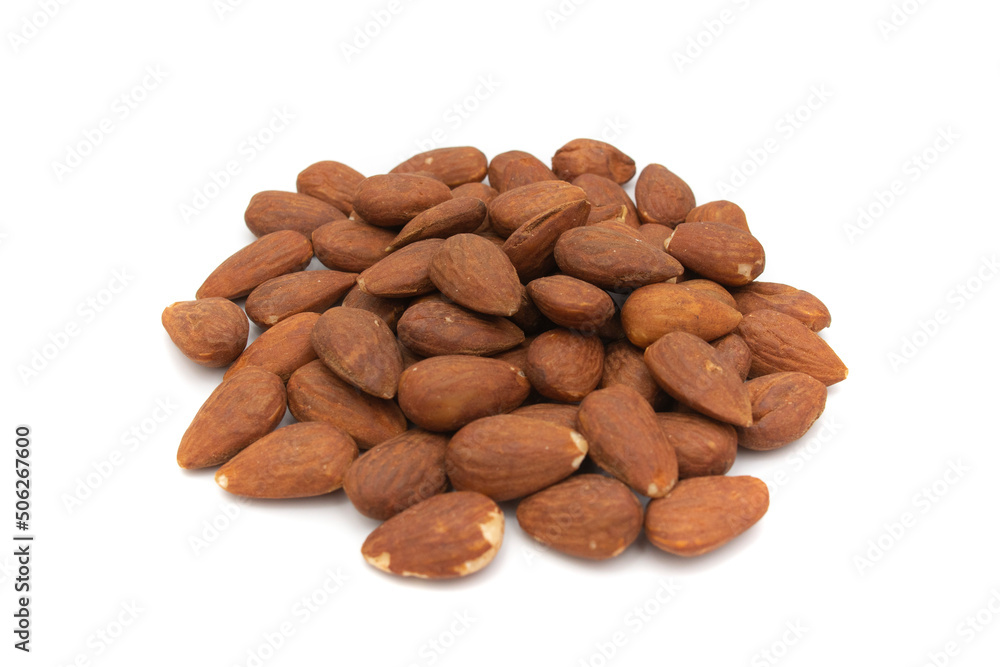 A handful of almonds, isolated on white background. The almond is the fruit of the almond tree (Prunus dulcis). It has a cinnamon-colored film that surrounds it as well as an outer shell. A handful of almonds, isolated on white background. The almond is the fruit of the almond tree (Prunus dulcis). It has a cinnamon-colored film that surrounds it as well as an outer shell.