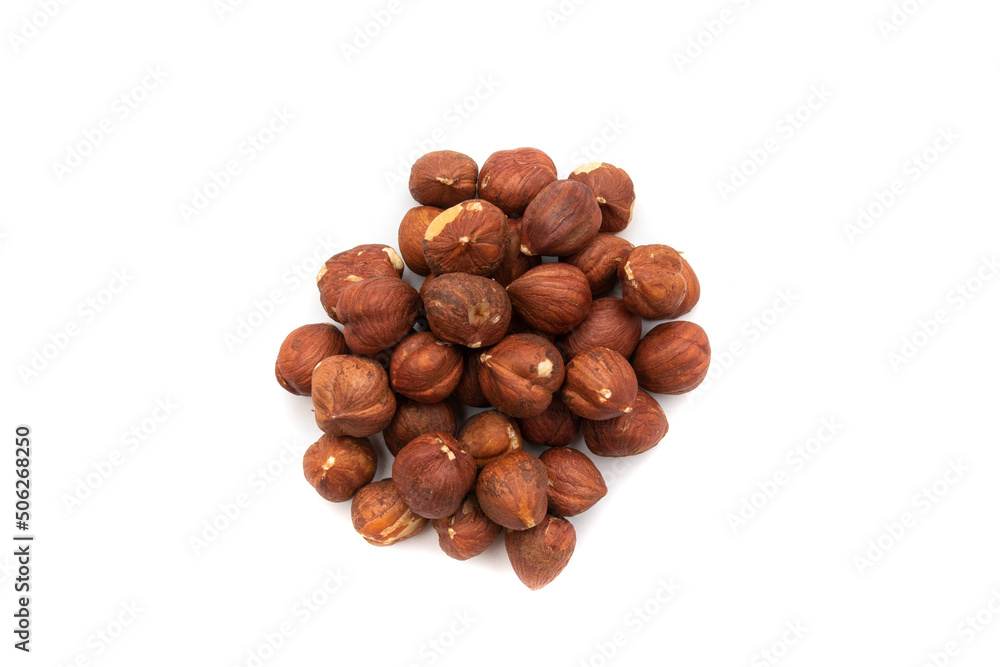 A handful of hazelnuts, isolated on white background.The hazelnut is the nut-like fruit of the common hazel, Corylus avellana. Etymologically it comes from the Latin nux abellana. A handful of hazelnuts, isolated on white background.The hazelnut is the nut-like fruit of the common hazel, Corylus avellana. Etymologically it comes from the Latin nux abellana.