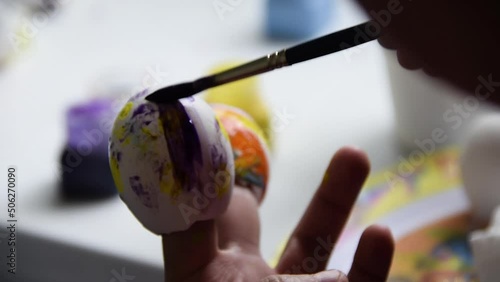 Children's craft made with eggshells painted with tempera, multi color school homework, primary school homework easter celebration.