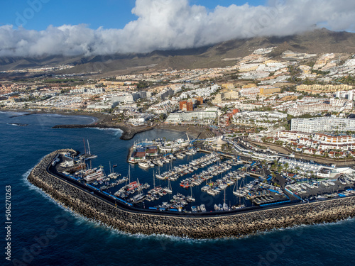 Aerial view on costline with sandy beaches and yachts harbor Puerto Colon on South of Tenerife near Costa Adeje, Canary islands, Spain