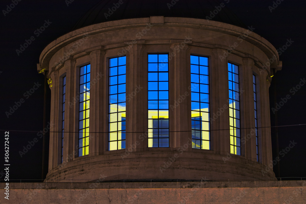 tower at night with windows highlighted in yellow and blue, colors of Ukraine