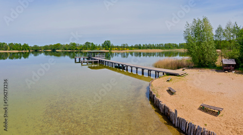 Fotografie View of the lake shore with gangway and the bower at sunny day in Karsko, Poland