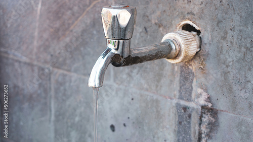 Wallpaper Mural Faucet or water tap on stone wall with water flowing. Torontodigital.ca