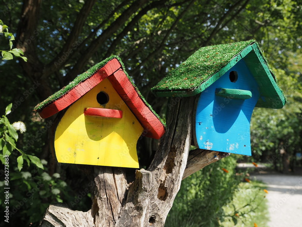 Pole with hanging colorful wooden birdhouses. Pole with hanging colorful wooden birdhouses.
