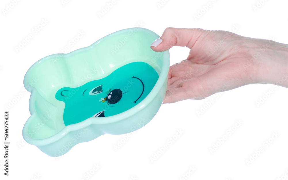 Children's plate dish in hand on white background isolation Children's plate dish in hand on white background isolation