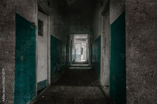 An old abandoned corridor in a pioneer camp. Light from doorways. Shabby walls. Forgotten place.